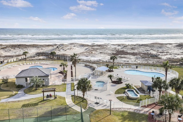 aerial view with a water view and a beach view