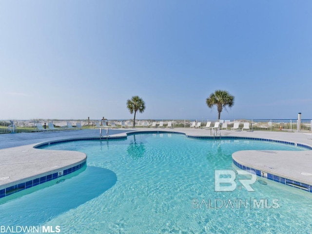 community pool featuring a patio area and fence