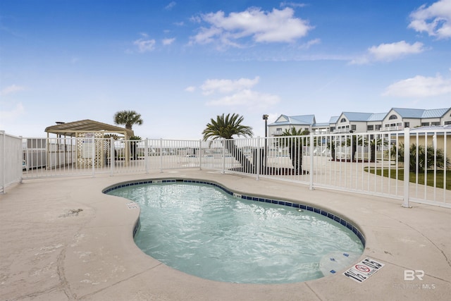 pool featuring a patio area and fence