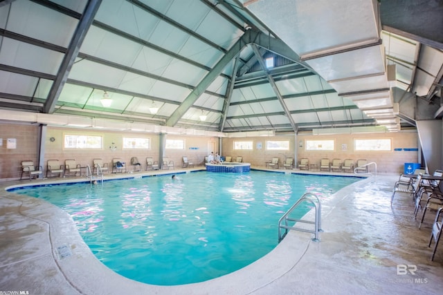 view of pool with a pool with connected hot tub