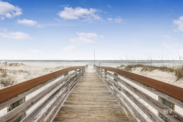 surrounding community with a water view and a view of the beach
