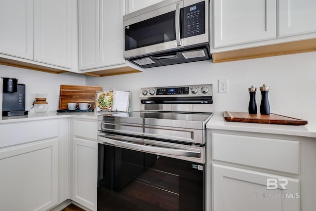 kitchen with light countertops, white cabinetry, and appliances with stainless steel finishes