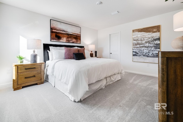 carpeted bedroom featuring baseboards and visible vents