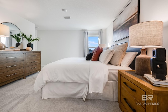 bedroom with light colored carpet and visible vents
