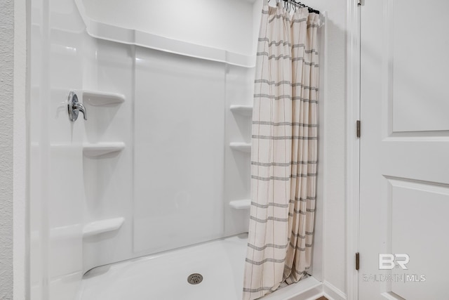 bathroom with a shower stall