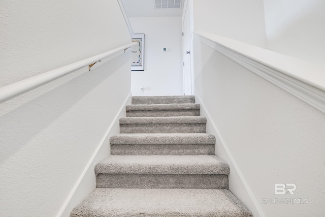stairway featuring visible vents