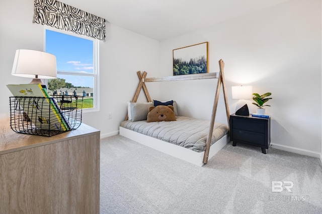 bedroom with baseboards and carpet