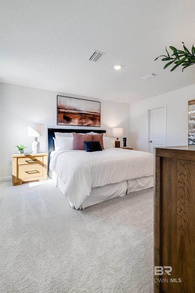carpeted bedroom with recessed lighting and visible vents