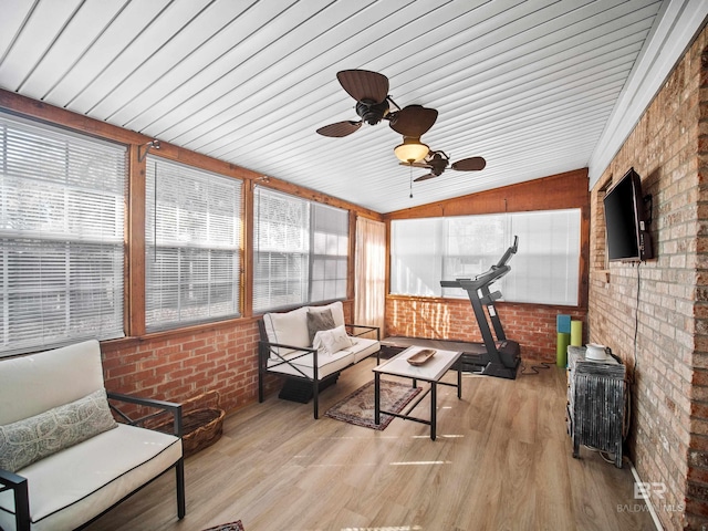 sunroom with ceiling fan and lofted ceiling