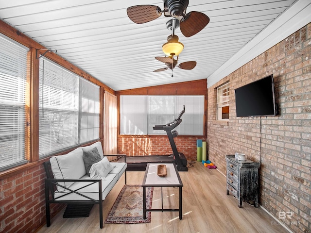 sunroom featuring vaulted ceiling and ceiling fan