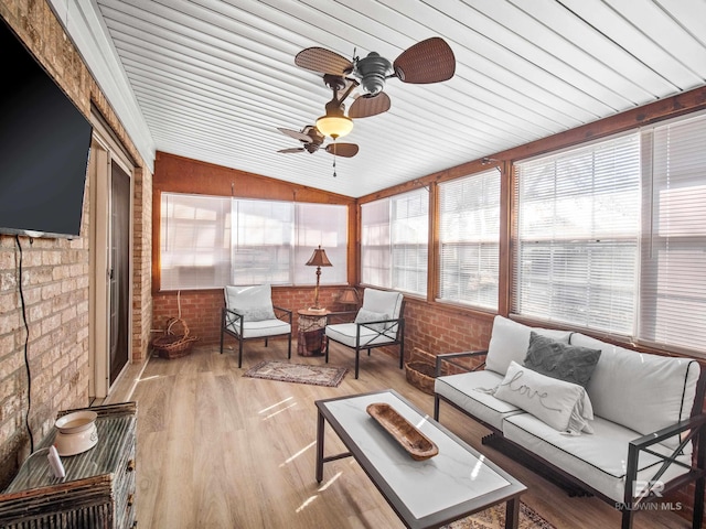 sunroom with lofted ceiling and ceiling fan