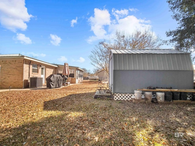 view of property exterior with cooling unit and a shed