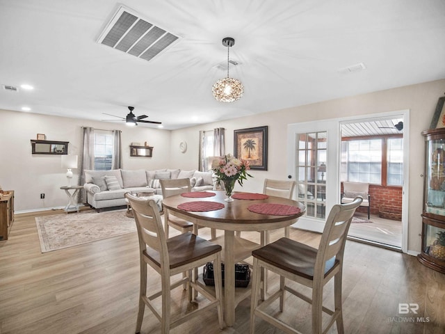 dining space with ceiling fan, hardwood / wood-style flooring, and a healthy amount of sunlight