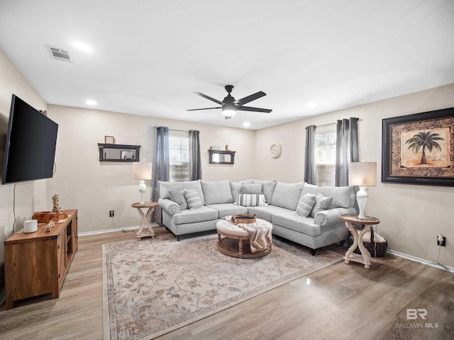 living room featuring ceiling fan and light wood-type flooring