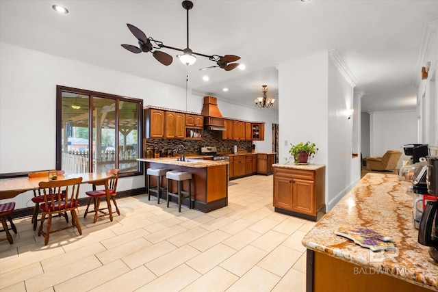 kitchen with decorative backsplash, ornamental molding, a breakfast bar, and premium range hood