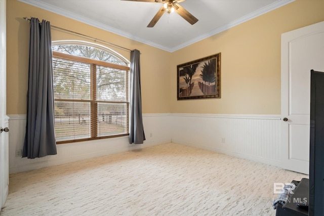 empty room with crown molding and ceiling fan