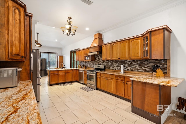 kitchen featuring pendant lighting, sink, appliances with stainless steel finishes, custom range hood, and kitchen peninsula