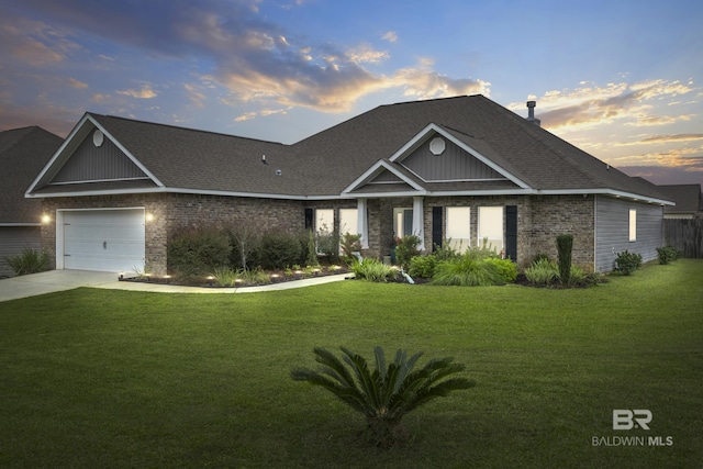 view of front of home featuring a lawn and a garage