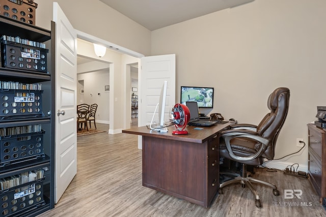 office area with light hardwood / wood-style floors