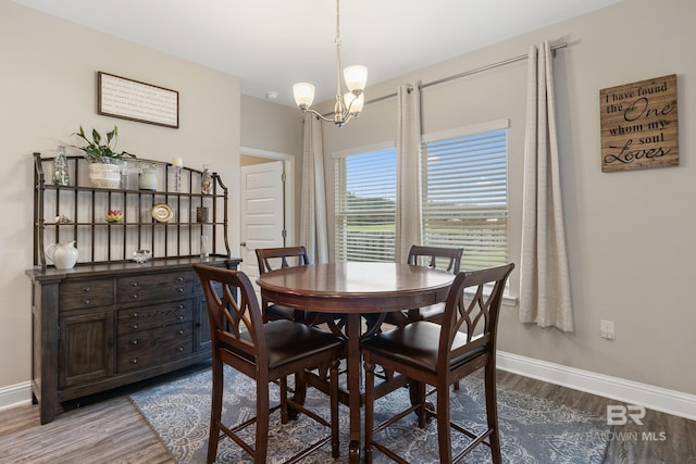 dining room featuring hardwood / wood-style flooring and an inviting chandelier