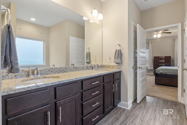 bathroom featuring wood-type flooring, vanity, and ceiling fan