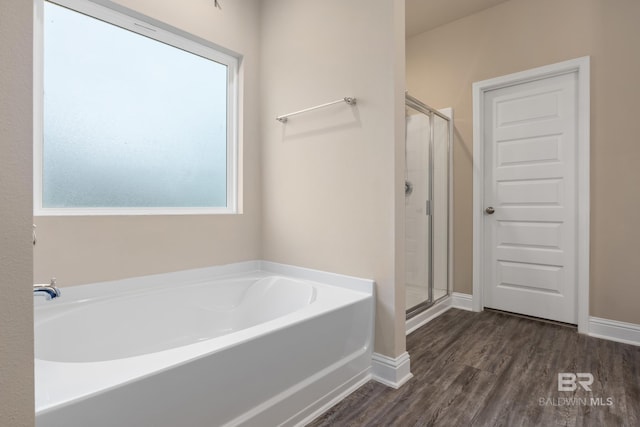 bathroom featuring separate shower and tub and hardwood / wood-style flooring