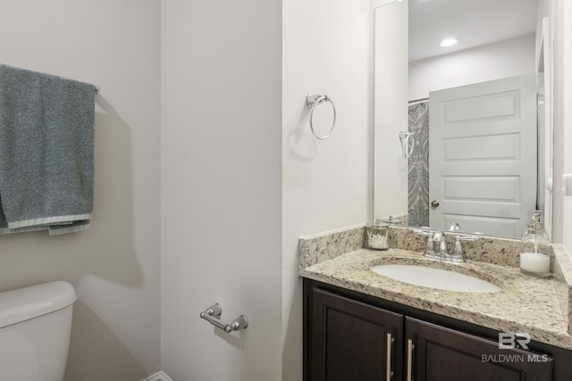 bathroom featuring vanity and toilet