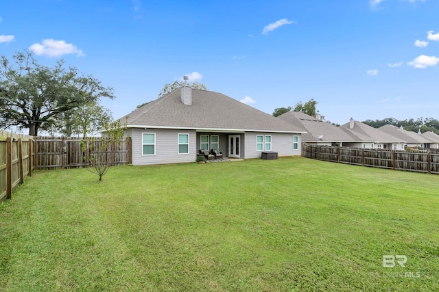 back of property featuring a lawn