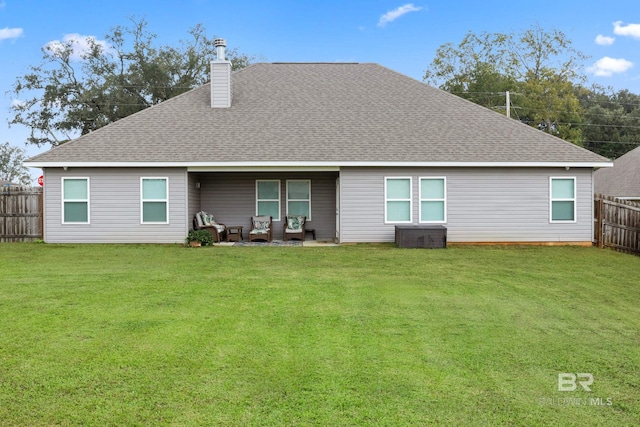 back of house with outdoor lounge area and a lawn