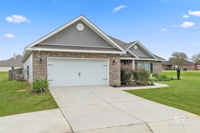 view of front of house featuring central AC unit, a garage, and a front yard