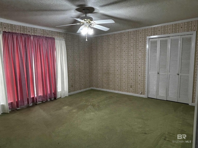 unfurnished bedroom featuring crown molding, carpet floors, a textured ceiling, a closet, and wallpapered walls