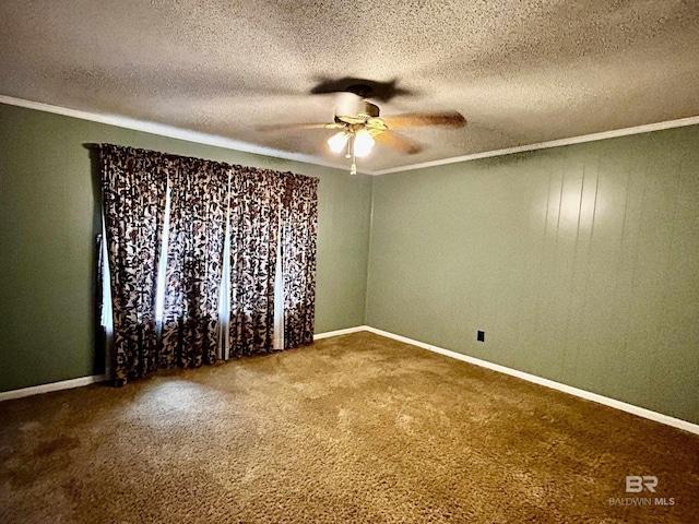carpeted spare room with crown molding, a ceiling fan, a textured ceiling, and baseboards