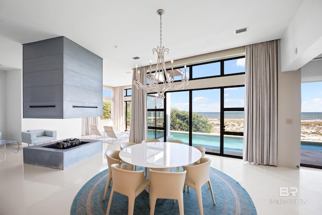 7276 Kiva Way, Gulf Shores, AL 36542 - dining space with a chandelier, healthy amount of natural light, a water view, and tile patterned floors