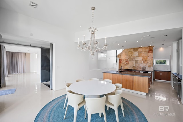 7276 Kiva Way, Gulf Shores, AL 36542 - dining space with a chandelier, concrete floors, and plenty of natural light