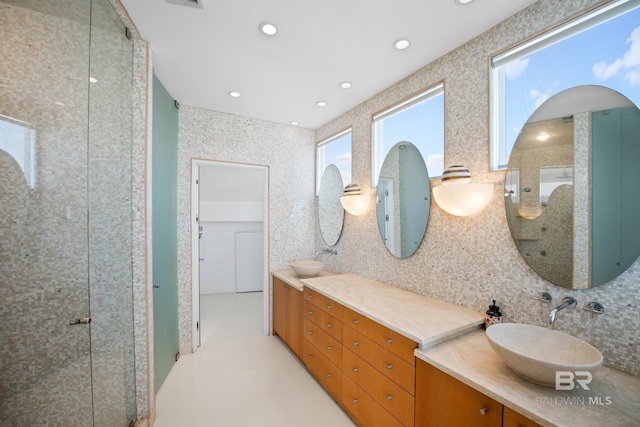 7276 Kiva Way, Gulf Shores, AL 36542 - bathroom featuring backsplash, a stall shower, double vanity, tile walls, and recessed lighting