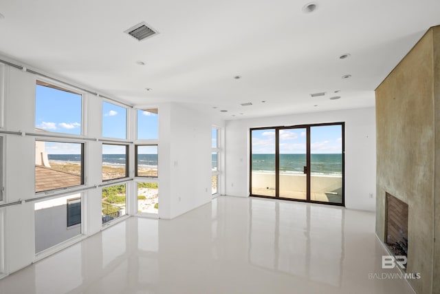 7276 Kiva Way, Gulf Shores, AL 36542 - empty room featuring view of water and beach, a fireplace, and recessed lighting