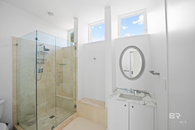 7276 Kiva Way, Gulf Shores, AL 36542 - bathroom featuring toilet, a shower stall, and vanity
