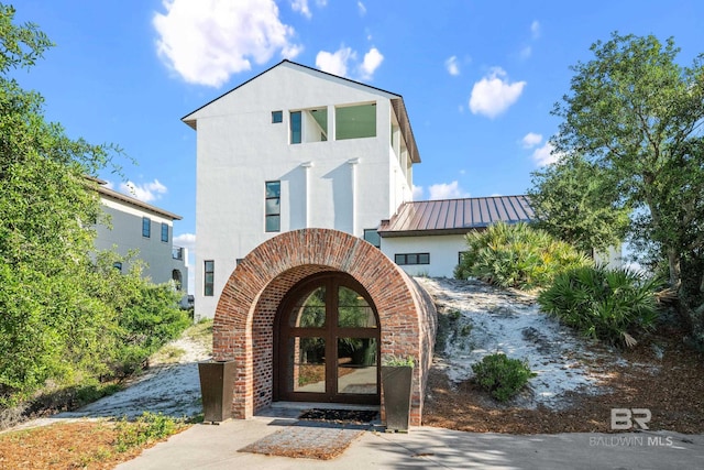 7276 Kiva Way, Gulf Shores, AL 36542 - view of front of property featuring a standing seam roof, french doors, metal roof, and stucco siding
