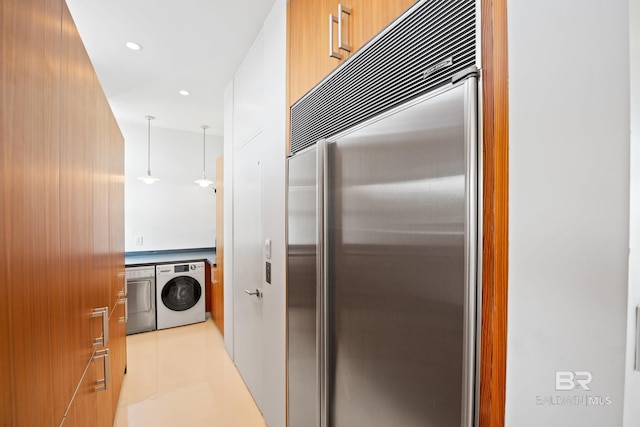 7276 Kiva Way, Gulf Shores, AL 36542 - kitchen with built in fridge, modern cabinets, washing machine and clothes dryer, and recessed lighting
