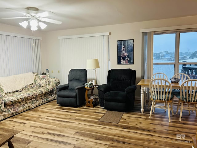 living room with wood finished floors and a ceiling fan