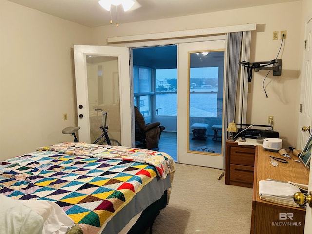 bedroom with light colored carpet and access to exterior