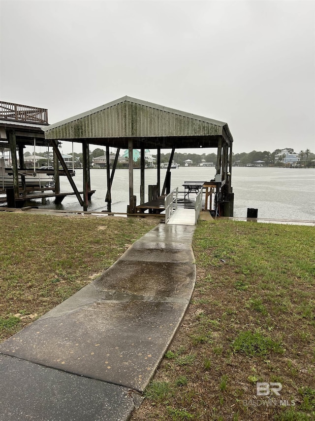 dock featuring a lawn and a water view