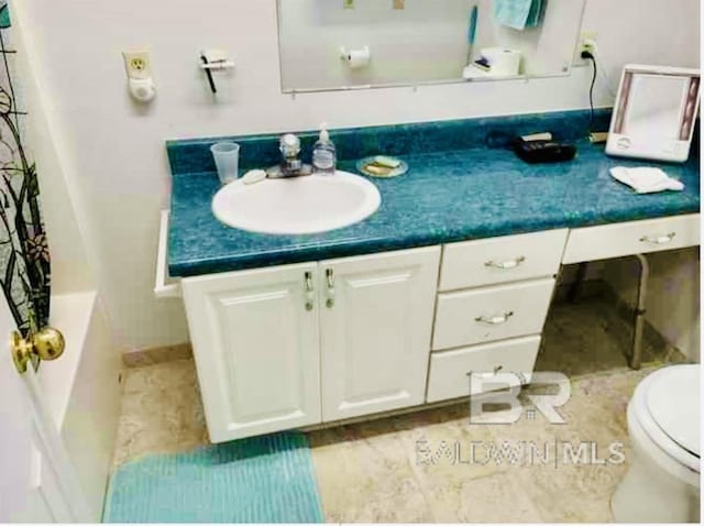 full bath featuring vanity and toilet