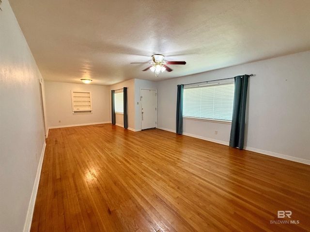 403 Sutherland Dr, Chickasaw, AL 36611 - spare room with light wood-style floors, healthy amount of natural light, ceiling fan, and baseboards