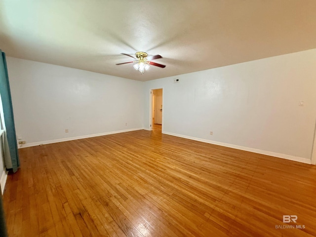 403 Sutherland Dr, Chickasaw, AL 36611 - spare room with a ceiling fan, hardwood / wood-style floors, and baseboards