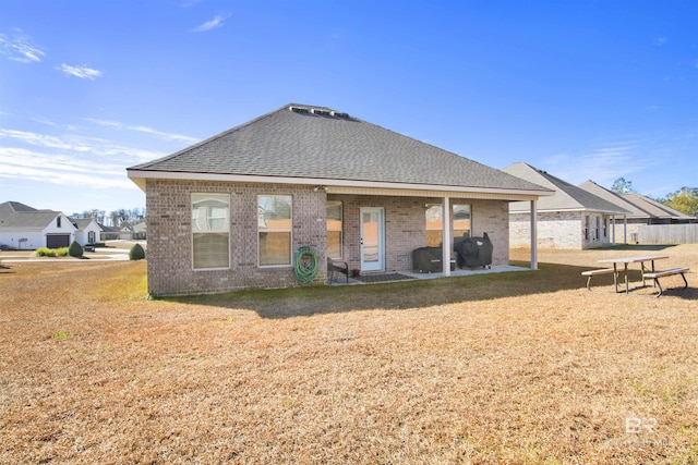 rear view of property with a yard