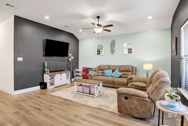 living room featuring lofted ceiling, ceiling fan, and light hardwood / wood-style floors