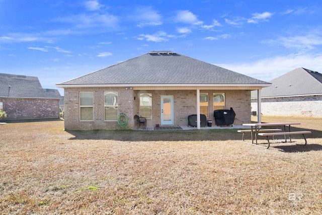 rear view of house featuring a yard