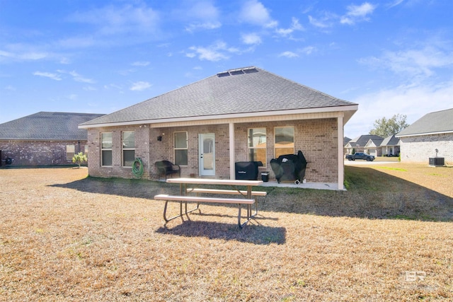 rear view of property with central AC unit