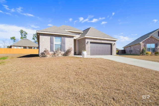 view of front of house featuring a front lawn and a garage